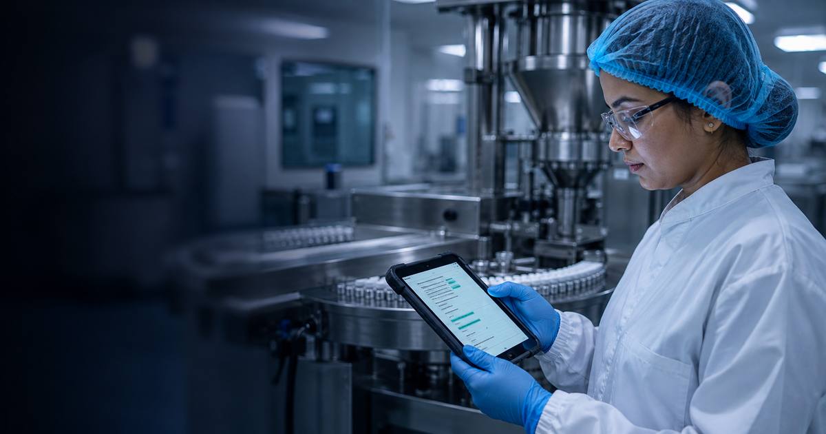 A quality assurance officer in cleanroom gown and gloves checking an AI-highlighted document on a handheld device beside a vial filling line.